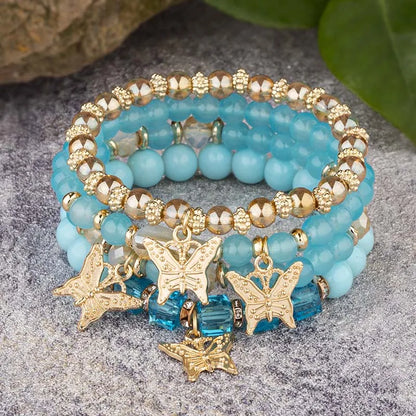 Lot de 4 bracelets tendance pour femme – Perles roses avec papillon, chaîne élastique, style bohème, parfait pour les fêtes et idées cadeaux